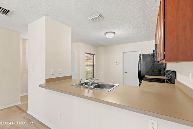 kitchen with light carpet, sink, black appliances, kitchen peninsula, and a textured ceiling