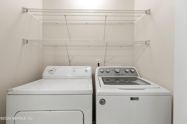 clothes washing area featuring separate washer and dryer