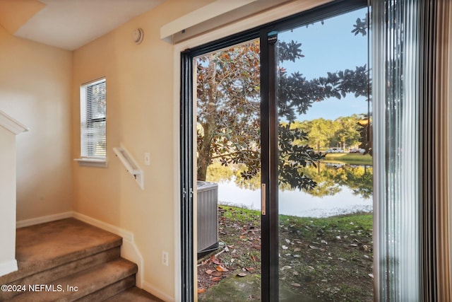 doorway to outside with a water view