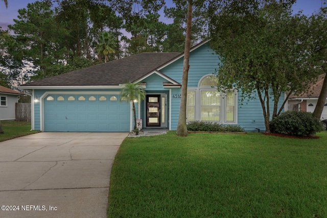 view of front of house with a lawn and a garage