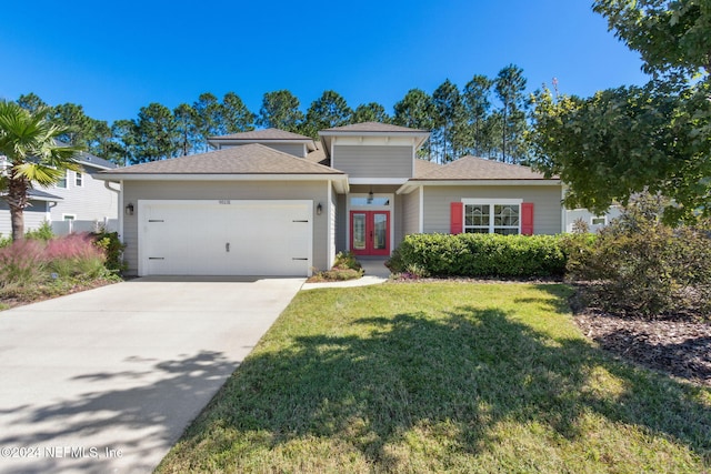 view of front of home with a front lawn and a garage