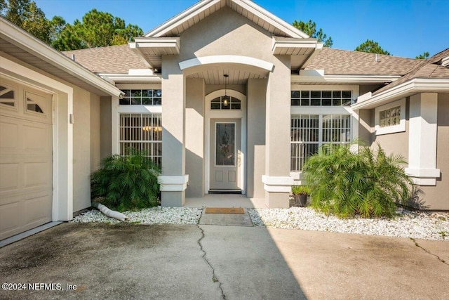 view of exterior entry with a garage