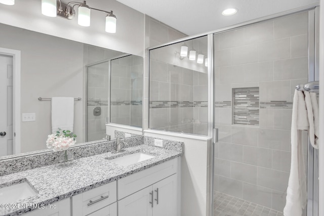 bathroom featuring vanity and an enclosed shower