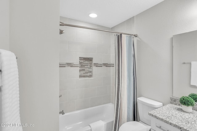 full bathroom featuring shower / bath combination with curtain, vanity, and toilet