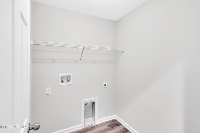 clothes washing area with washer hookup, wood-type flooring, and hookup for an electric dryer