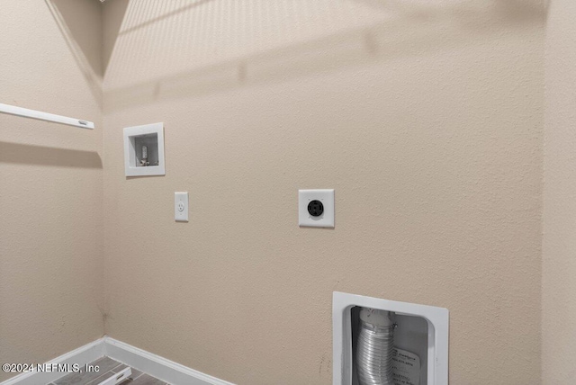 clothes washing area featuring hookup for a washing machine and electric dryer hookup