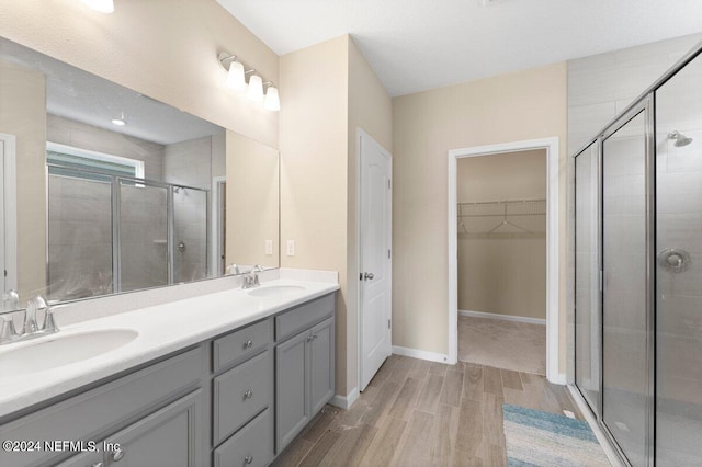 bathroom featuring vanity, a shower with shower door, and hardwood / wood-style floors