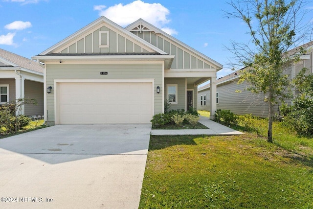 craftsman inspired home featuring a garage and a front lawn