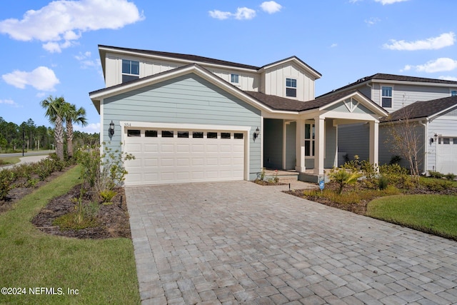 view of front of house featuring a porch and a garage