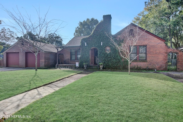 view of front of house with a garage and a front yard