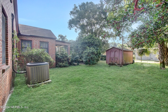 view of yard with central AC unit and a storage shed