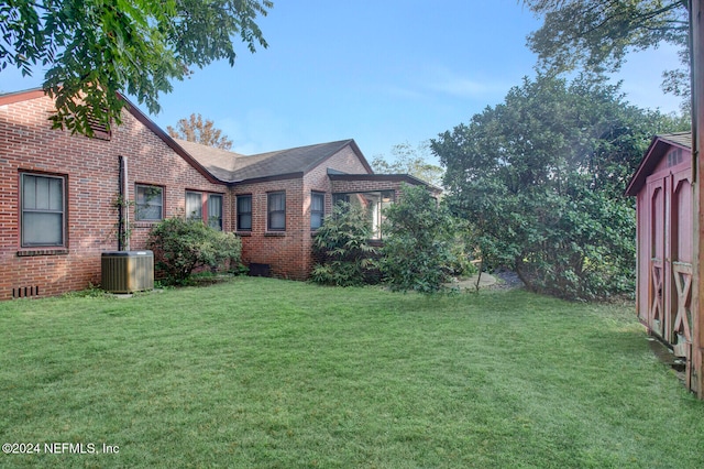 view of property exterior featuring central AC and a lawn