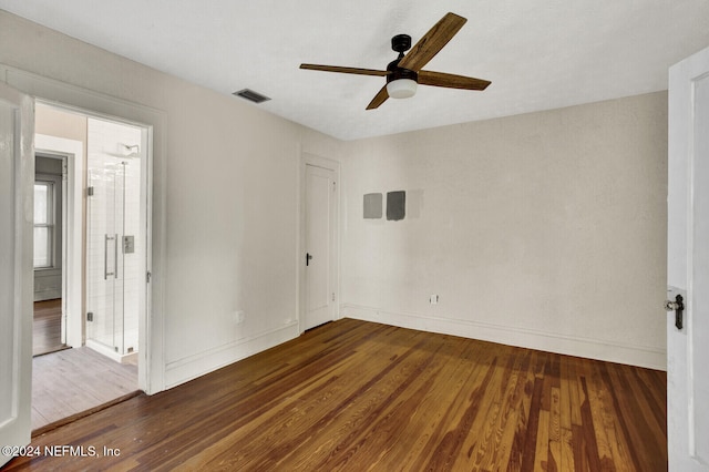 empty room featuring dark hardwood / wood-style floors and ceiling fan