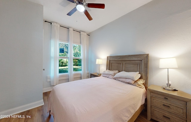 bedroom featuring ceiling fan, vaulted ceiling, and hardwood / wood-style floors