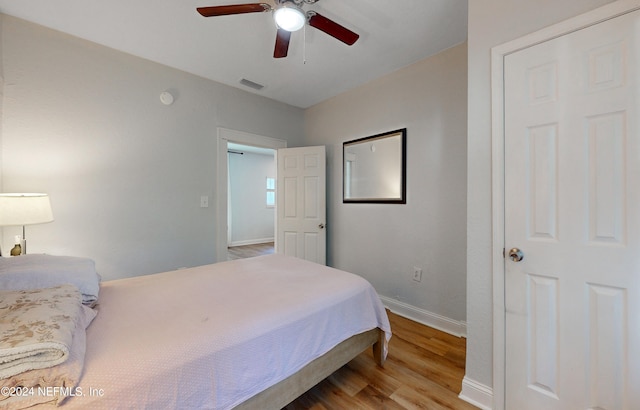 bedroom with ceiling fan and light hardwood / wood-style flooring