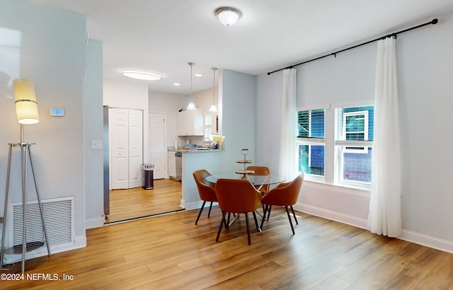 dining space with light hardwood / wood-style floors