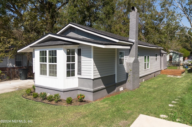 view of side of property with a lawn