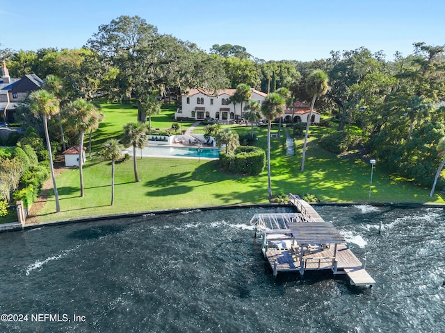 view of home's community featuring a pool, a water view, a lawn, and a boat dock