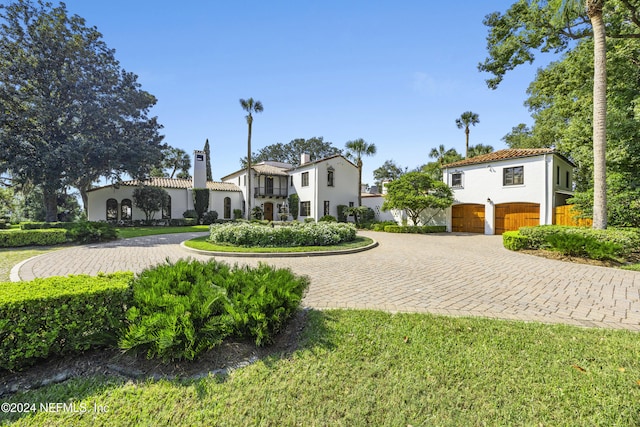 view of front facade with a front yard and a garage