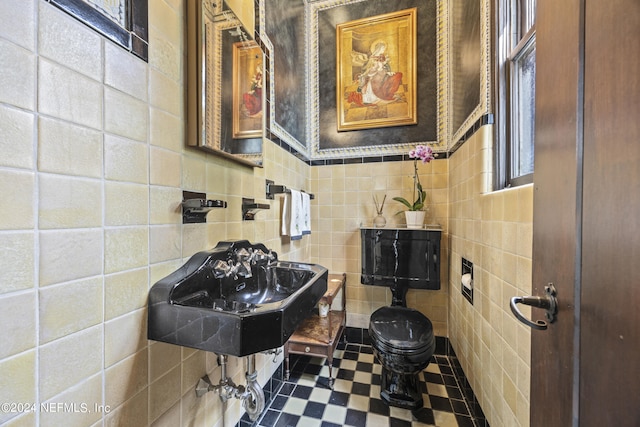 bathroom featuring toilet and tile walls