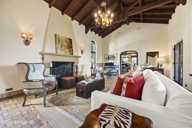 living room featuring wood ceiling, a large fireplace, an inviting chandelier, high vaulted ceiling, and beamed ceiling