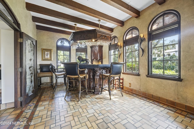 interior space with beam ceiling and plenty of natural light