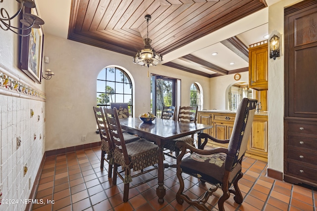 dining room with wood ceiling, ornamental molding, and dark tile patterned flooring