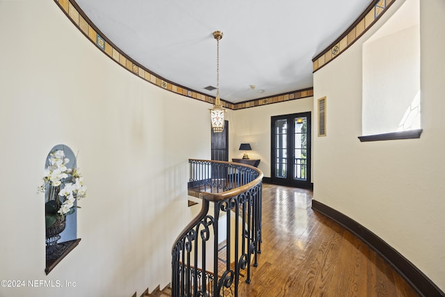 hallway featuring hardwood / wood-style floors and french doors