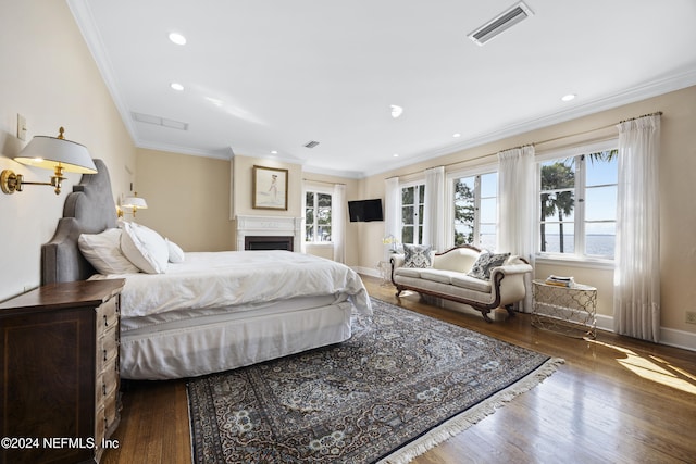 bedroom featuring crown molding, multiple windows, and dark hardwood / wood-style flooring