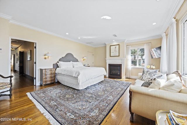 bedroom with ornamental molding and dark wood-type flooring