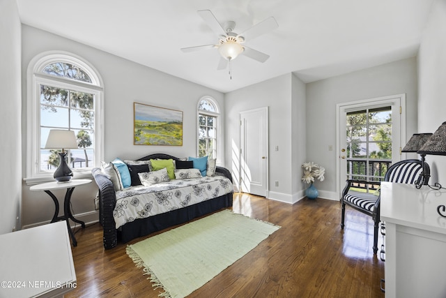 bedroom with dark hardwood / wood-style floors and ceiling fan