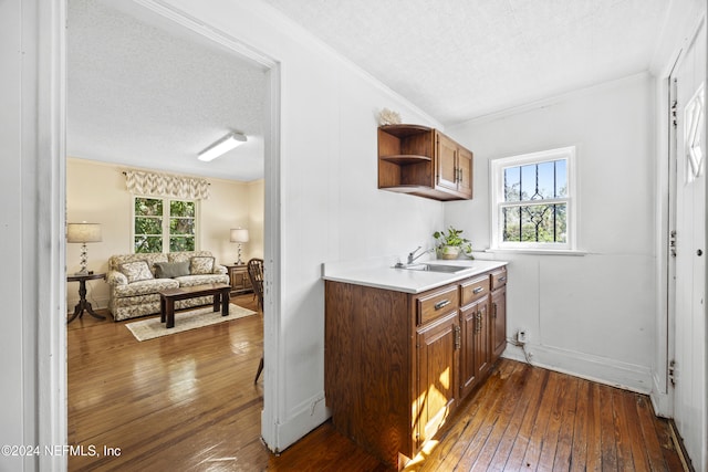 kitchen with dark hardwood / wood-style floors, a textured ceiling, and a wealth of natural light