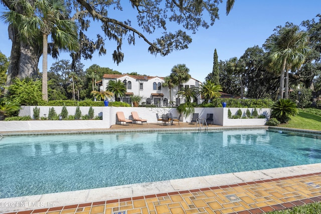 view of swimming pool with a patio