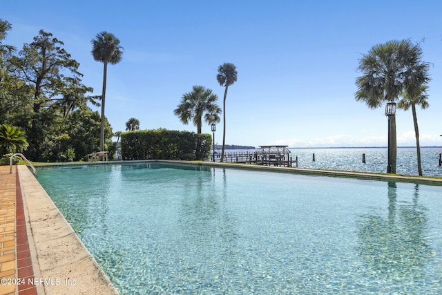 view of pool featuring a water view