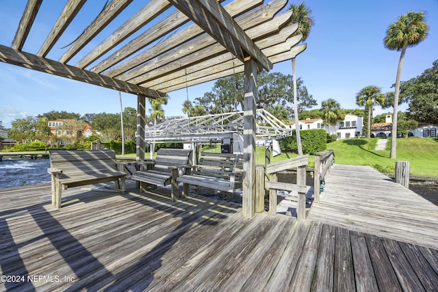 dock area with a water view and a pergola