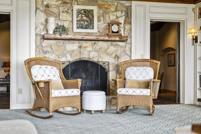 living area featuring a stone fireplace