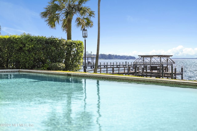 view of swimming pool with a water view