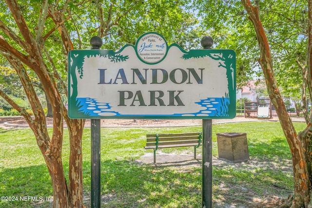 community / neighborhood sign with a yard