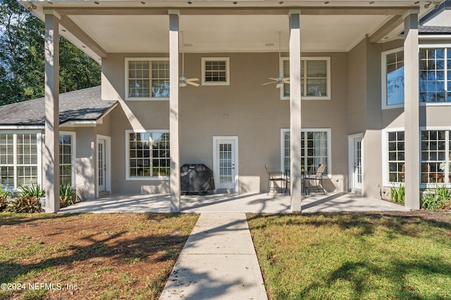 13601 Emerald Cove Ct, Jacksonville, FL 32225 - rear view of house featuring a shingled roof, stucco siding, a patio area, ceiling fan, and a lawn