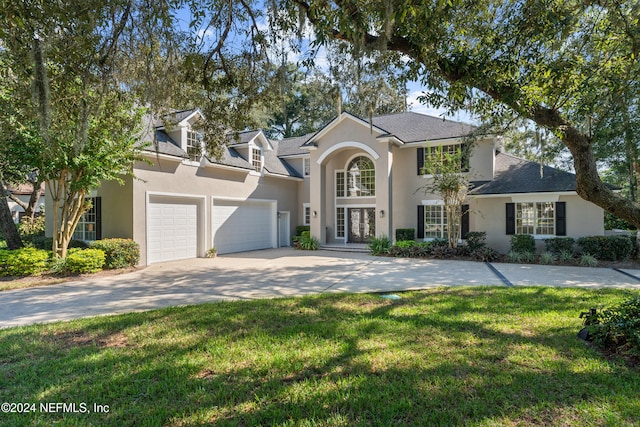 13601 Emerald Cove Ct, Jacksonville, FL 32225 - view of front of home featuring a garage, concrete driveway, a front lawn, and stucco siding
