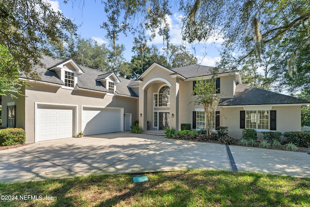 13601 Emerald Cove Ct, Jacksonville, FL 32225 - traditional-style house with an attached garage, a shingled roof, concrete driveway, and stucco siding