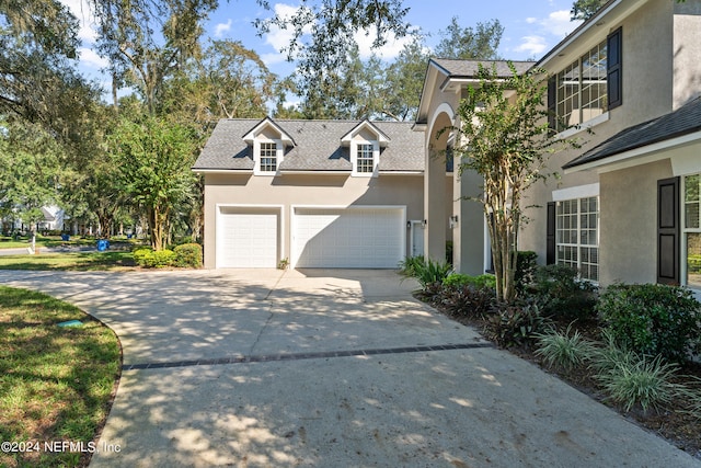 13601 Emerald Cove Ct, Jacksonville, FL 32225 - view of front facade featuring an attached garage, driveway, a shingled roof, and stucco siding
