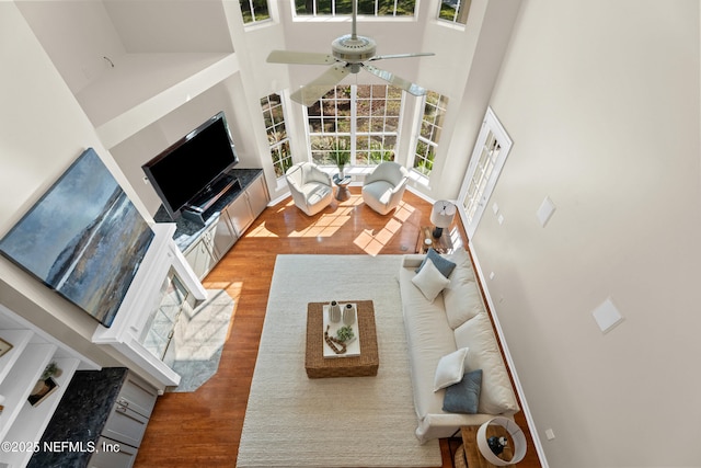 13601 Emerald Cove Ct, Jacksonville, FL 32225 - living room with baseboards, wood finished floors, a high ceiling, and ceiling fan