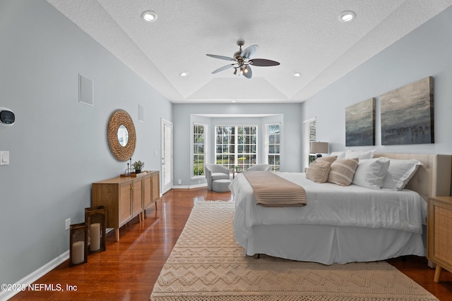 13601 Emerald Cove Ct, Jacksonville, FL 32225 - bedroom featuring a tray ceiling, a textured ceiling, baseboards, visible vents, and dark wood-type flooring