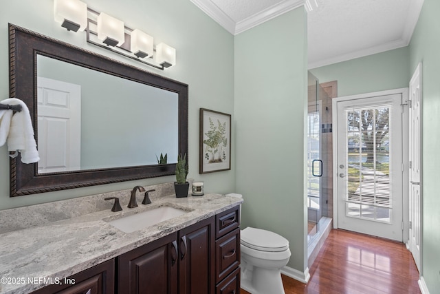 13601 Emerald Cove Ct, Jacksonville, FL 32225 - full bathroom featuring crown molding, wood finished floors, a stall shower, vanity, and toilet