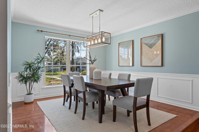 13601 Emerald Cove Ct, Jacksonville, FL 32225 - dining space with a wainscoted wall, a wealth of natural light, and crown molding