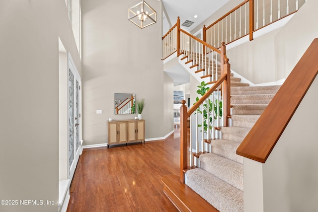 13601 Emerald Cove Ct, Jacksonville, FL 32225 - foyer entrance with a towering ceiling, visible vents, a chandelier, wood finished floors, and stairway