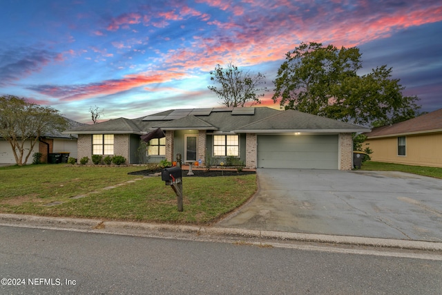 view of front of house with a yard and a garage