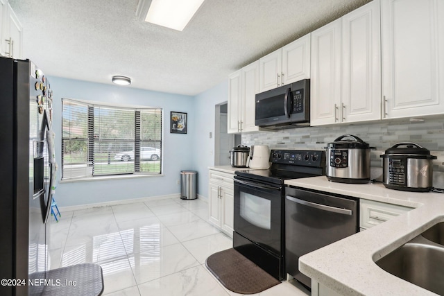 kitchen with white cabinets, tasteful backsplash, appliances with stainless steel finishes, a textured ceiling, and light stone countertops