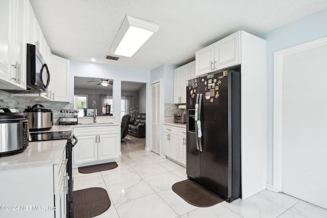 kitchen featuring white cabinetry, ceiling fan, black / electric stove, decorative backsplash, and refrigerator with ice dispenser